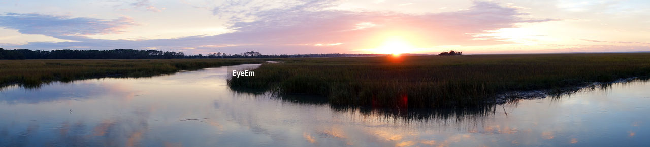 Scenic view of lake against sky during sunset