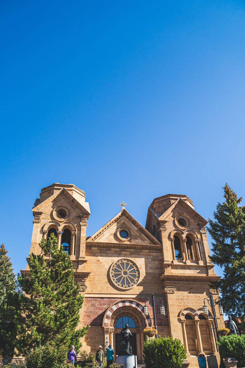 LOW ANGLE VIEW OF CATHEDRAL AGAINST BLUE SKY