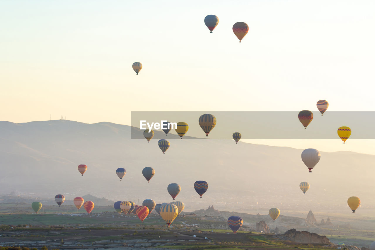 LOW ANGLE VIEW OF HOT AIR BALLOONS FLYING AGAINST SKY