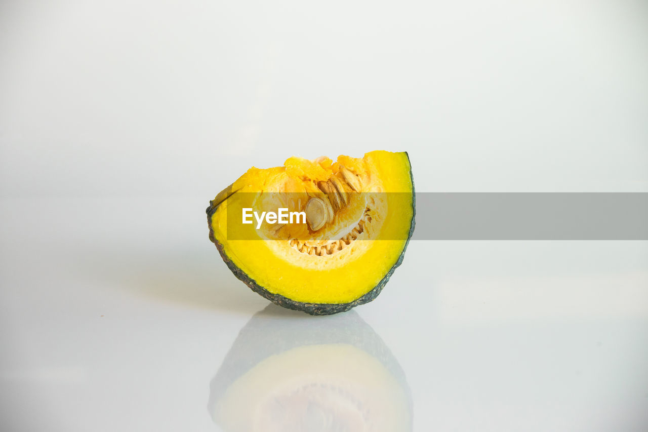 CLOSE-UP OF YELLOW CAKE AGAINST GRAY BACKGROUND