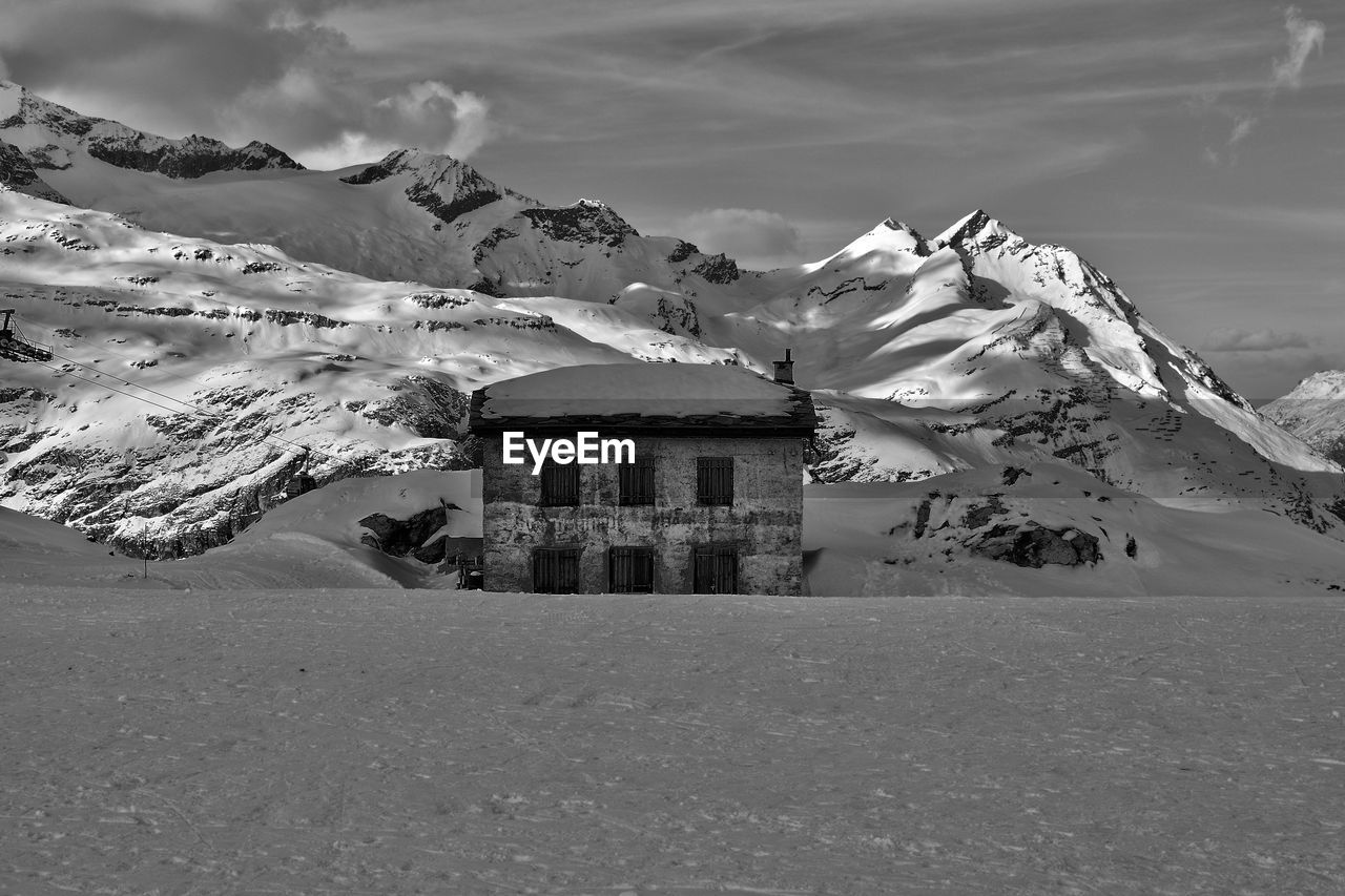 Zermatt houses on snowcapped mountain against sky