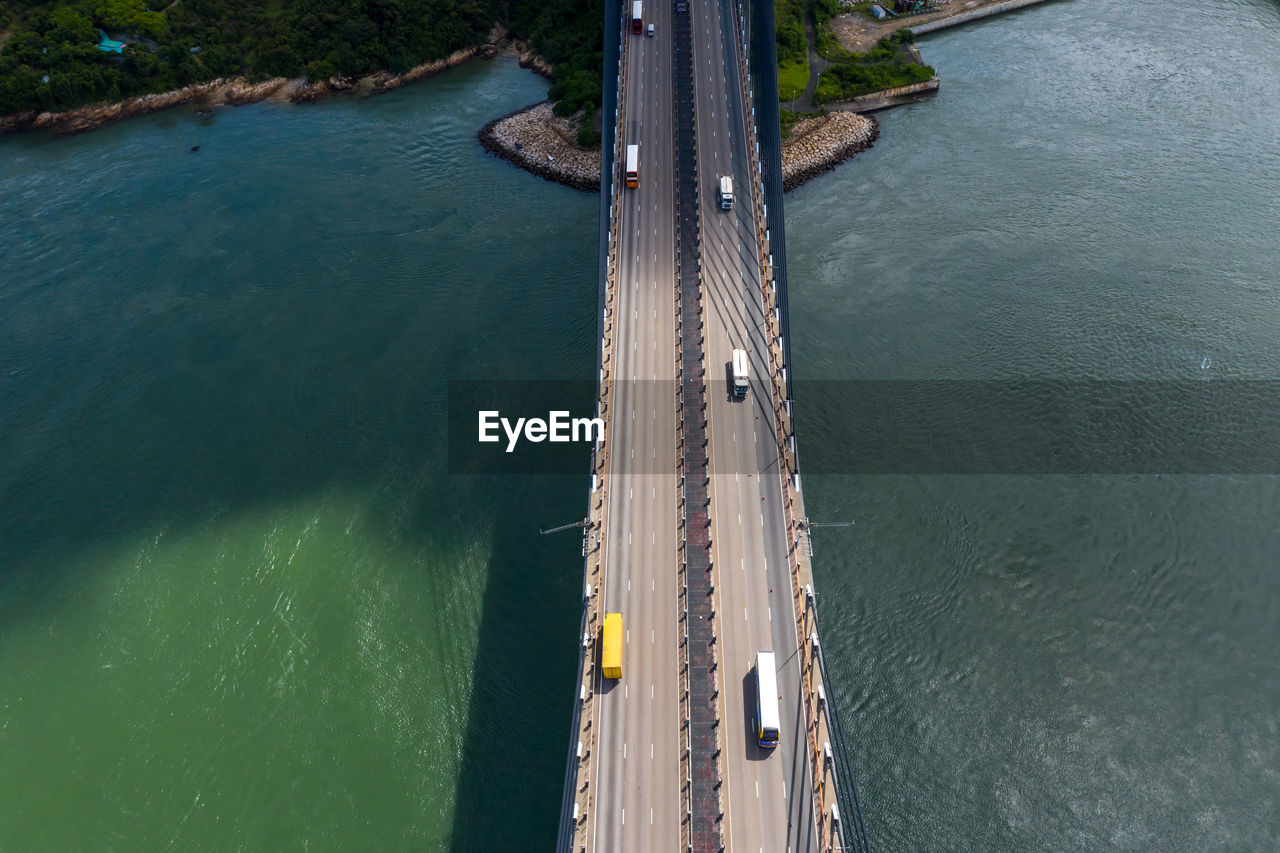 Drone view of vehicles on bridge over sea