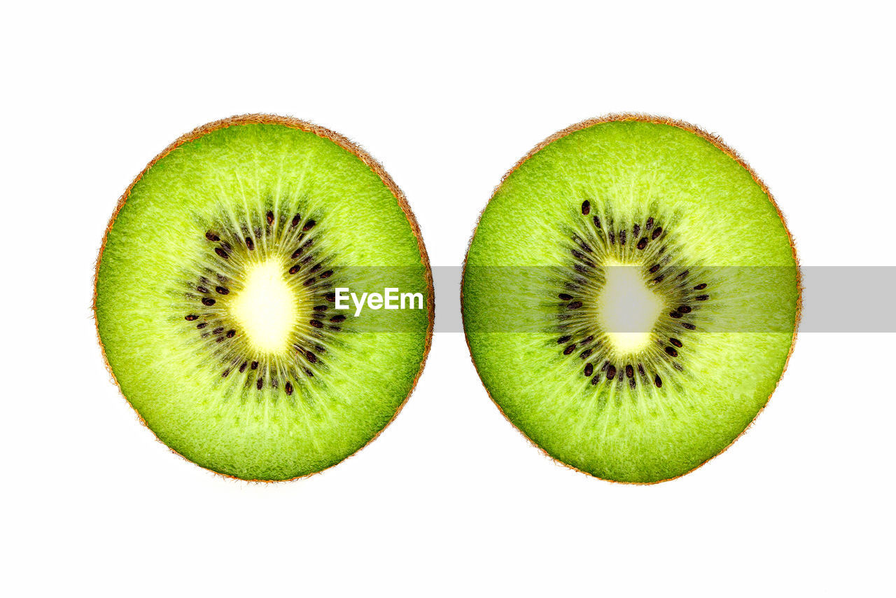 Close-up of kiwis against white background