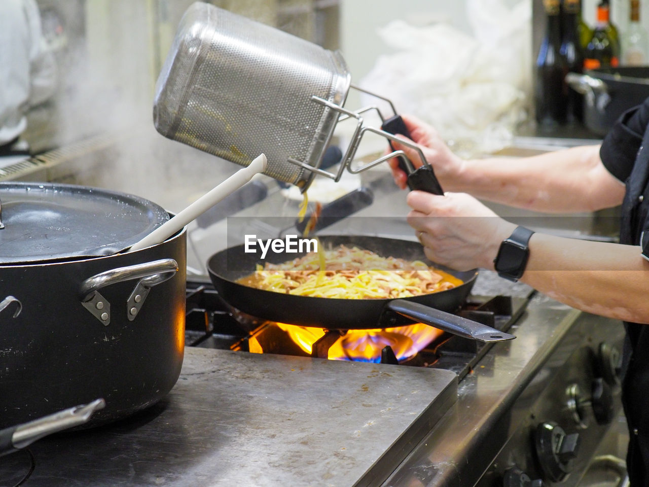 cropped hand of man preparing food in kitchen