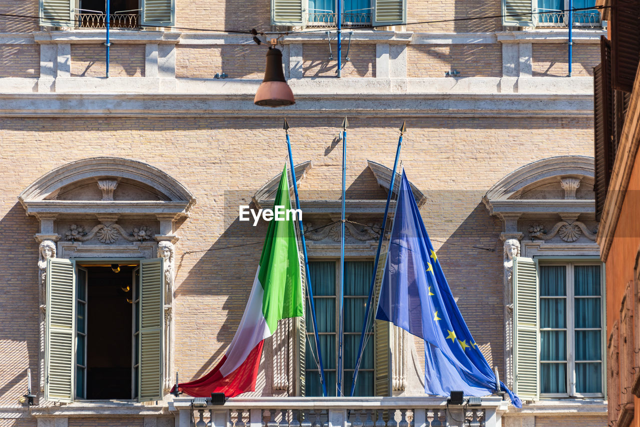 LOW ANGLE VIEW OF FLAG HANGING ON BUILDING