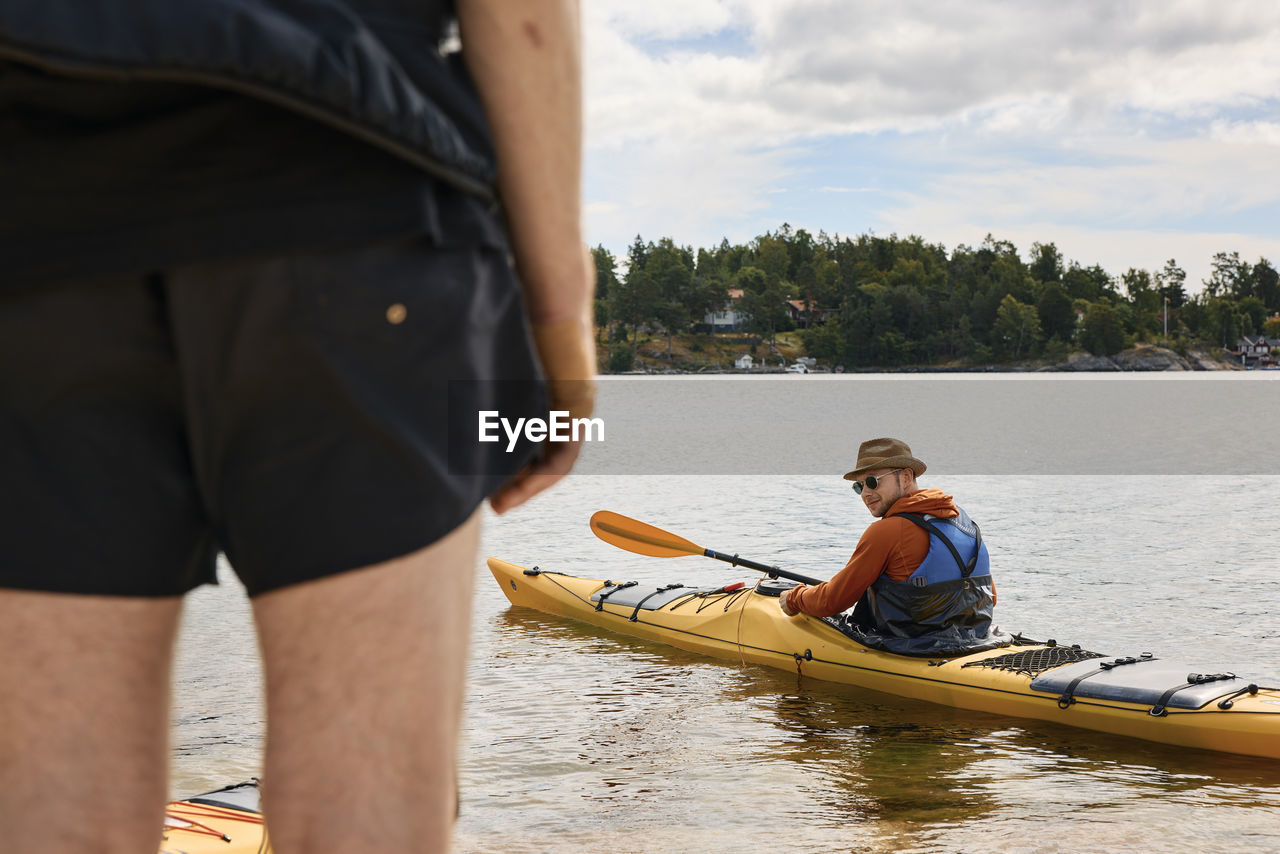View of man sitting in kayak on water