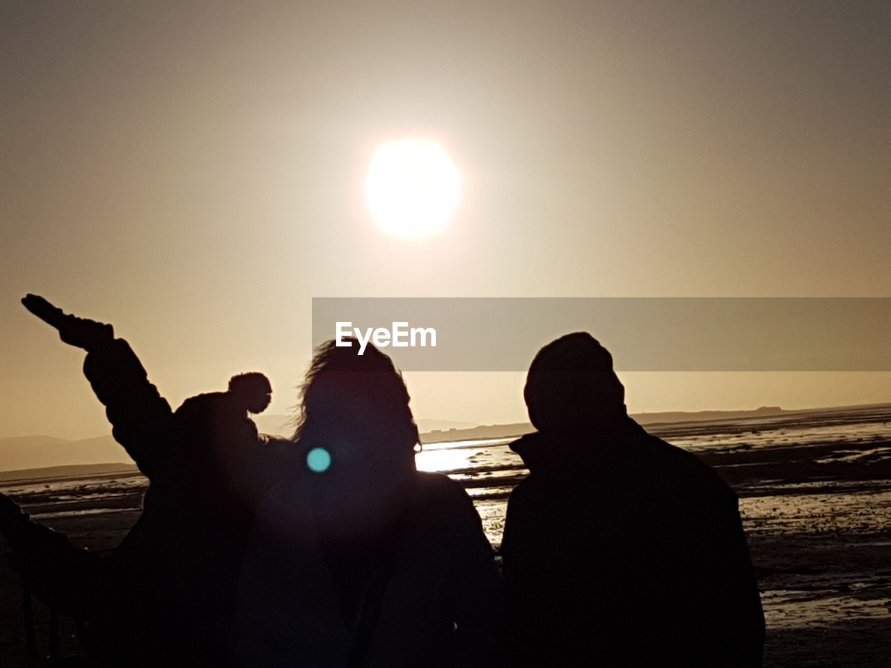 SILHOUETTE PEOPLE PHOTOGRAPHING ON BEACH AGAINST CLEAR SKY