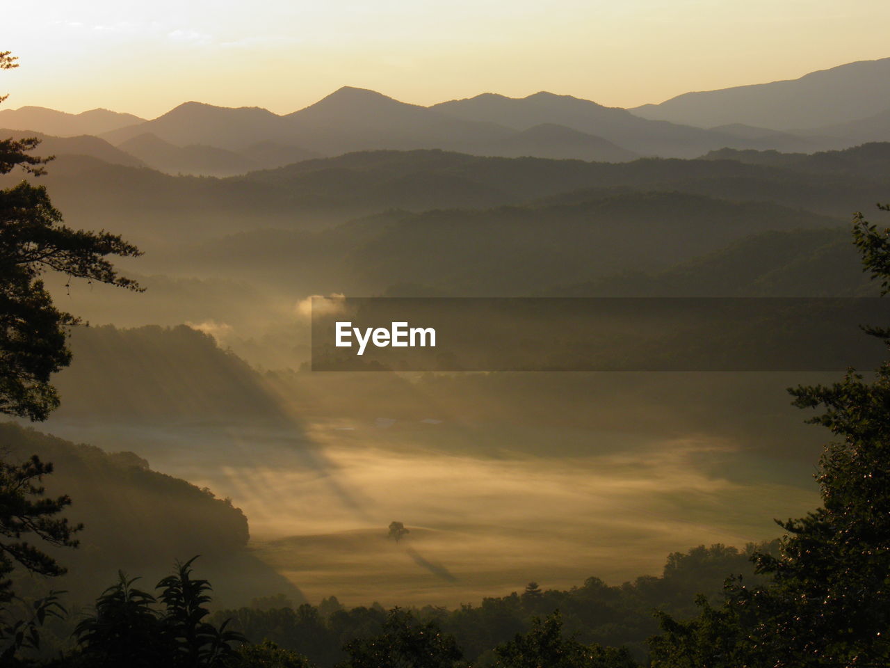 Scenic view of silhouette mountains against sky at sunset