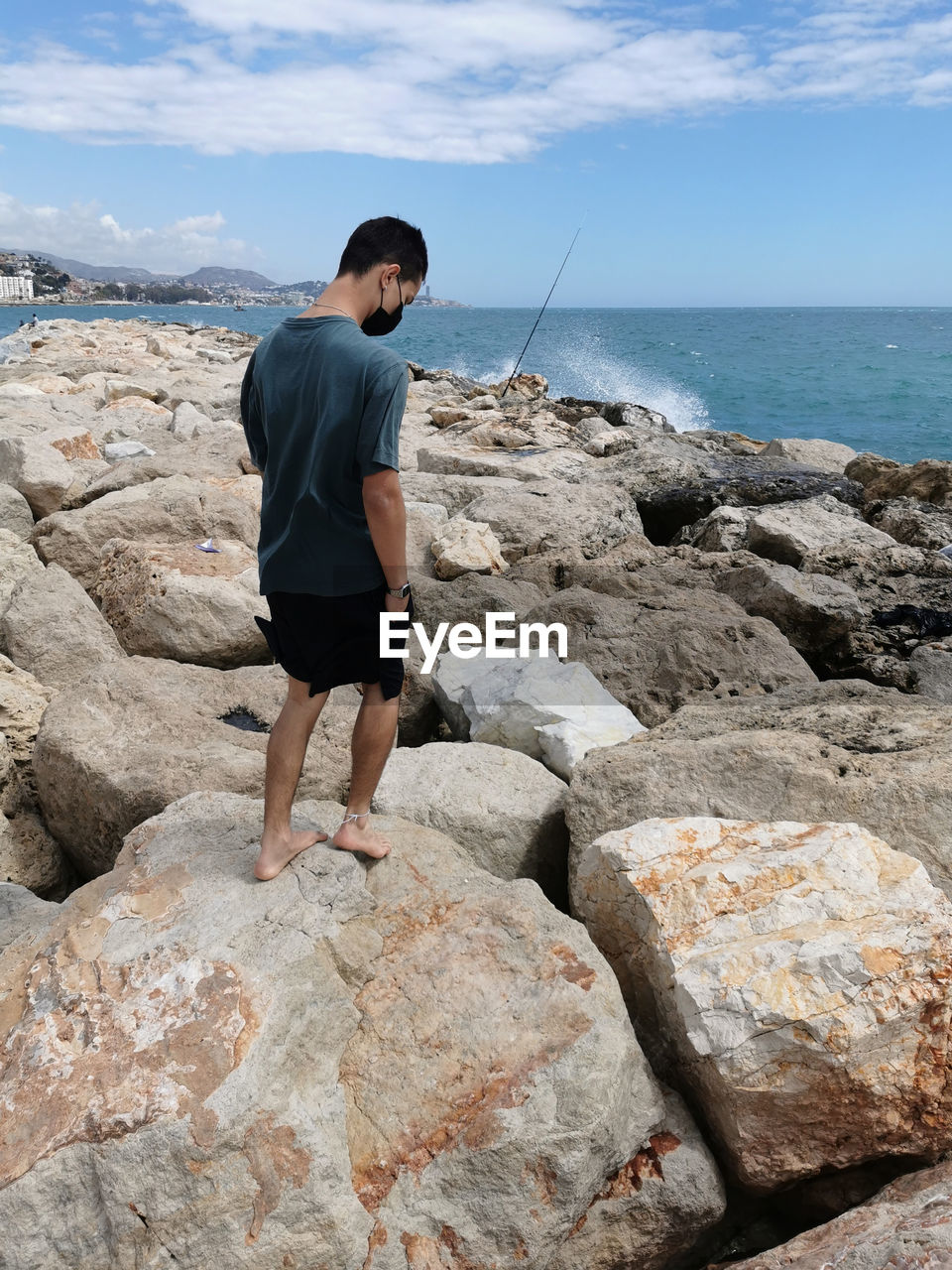 FULL LENGTH OF MAN STANDING ON ROCK