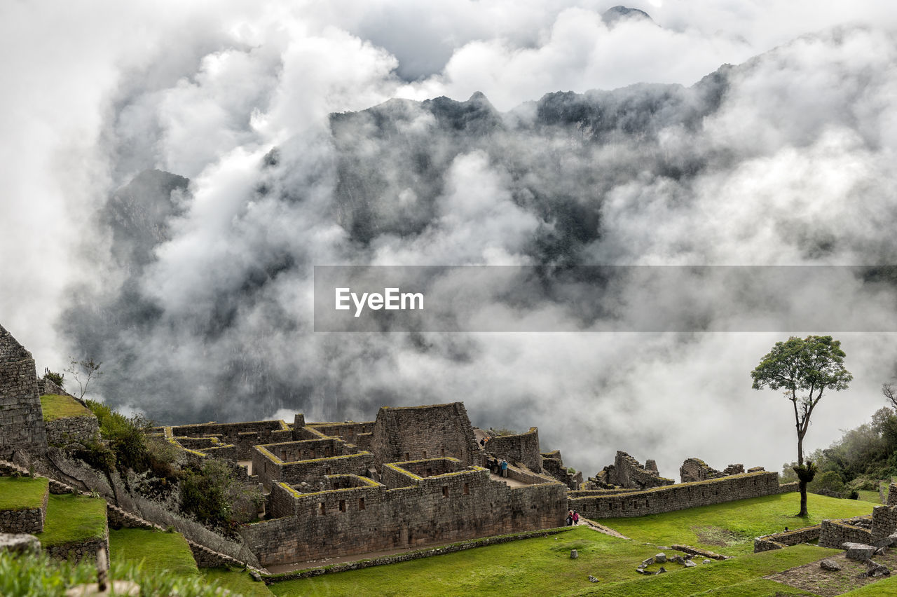 Panoramic view of castle against cloudy sky, machu picchu, peru