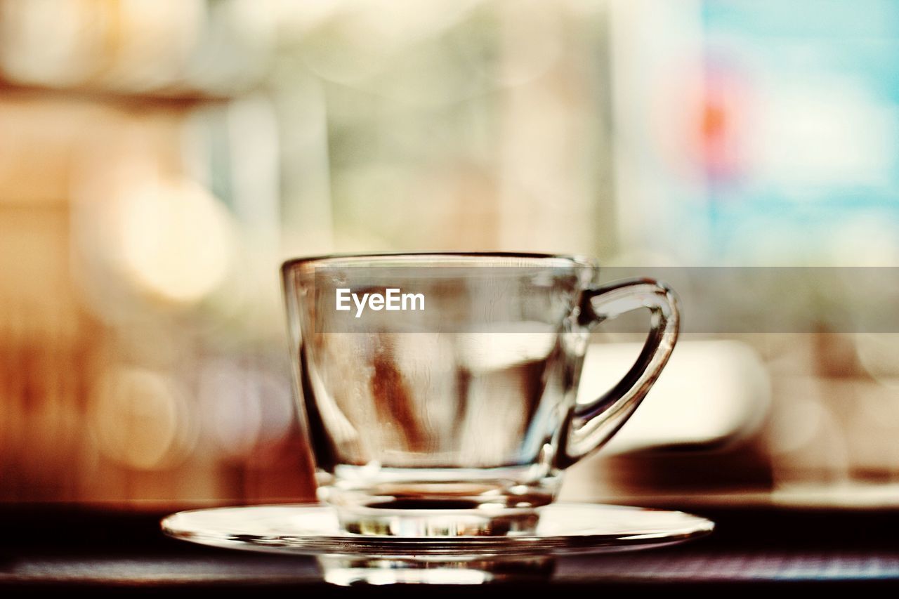 Close-up of empty glass cup on table