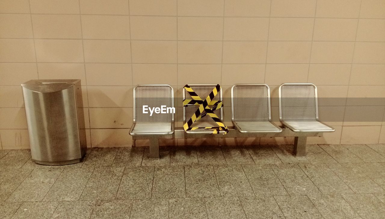 Empty chairs at underground walkway