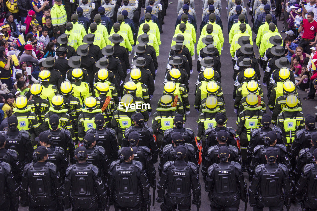 High angle view of people in uniform standing on road