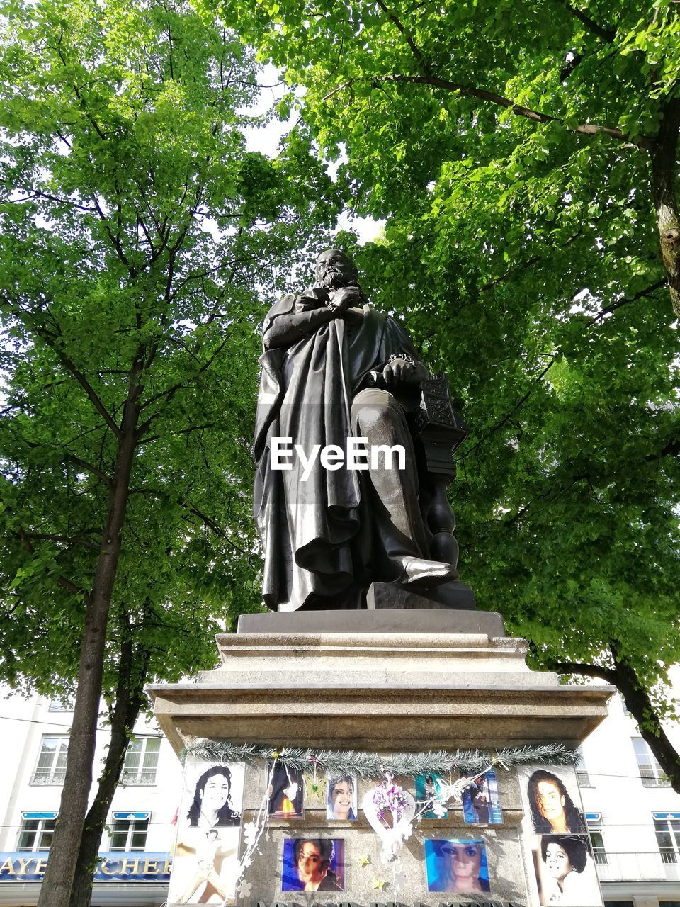 LOW ANGLE VIEW OF STATUES AGAINST TREES