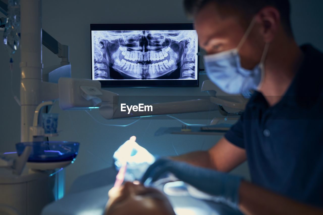 Dentist examining girl at clinic