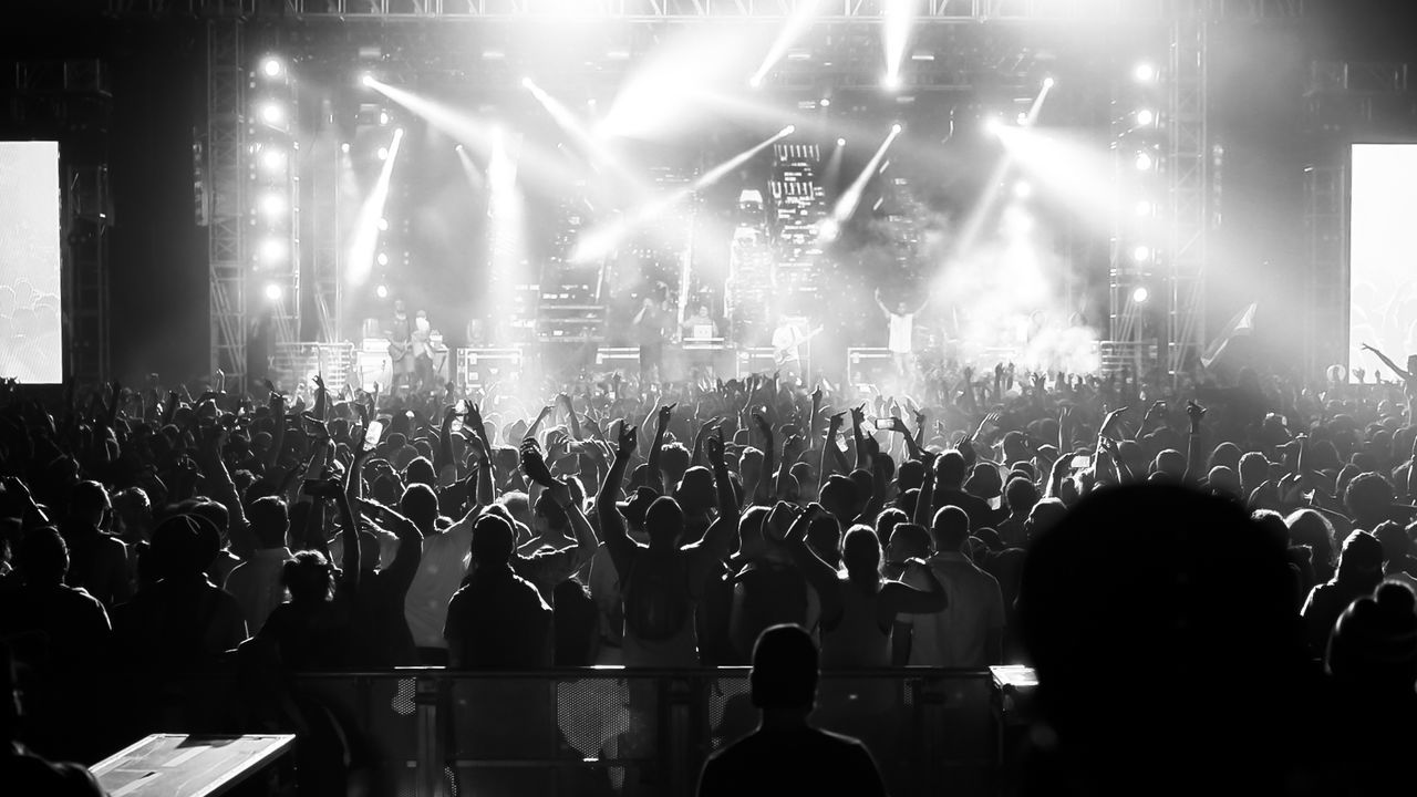 REAR VIEW OF PEOPLE WATCHING MUSIC CONCERT