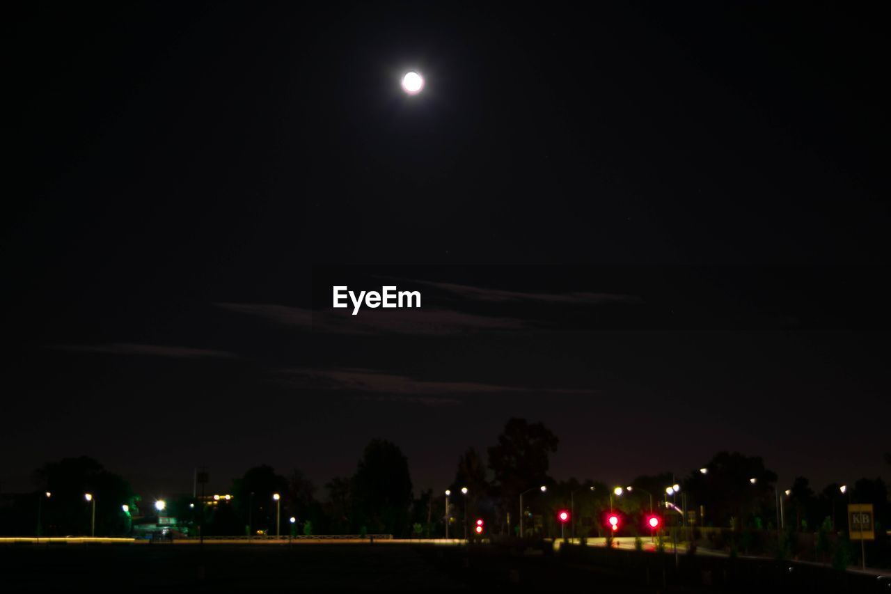 LIGHT TRAILS ON LANDSCAPE AT NIGHT