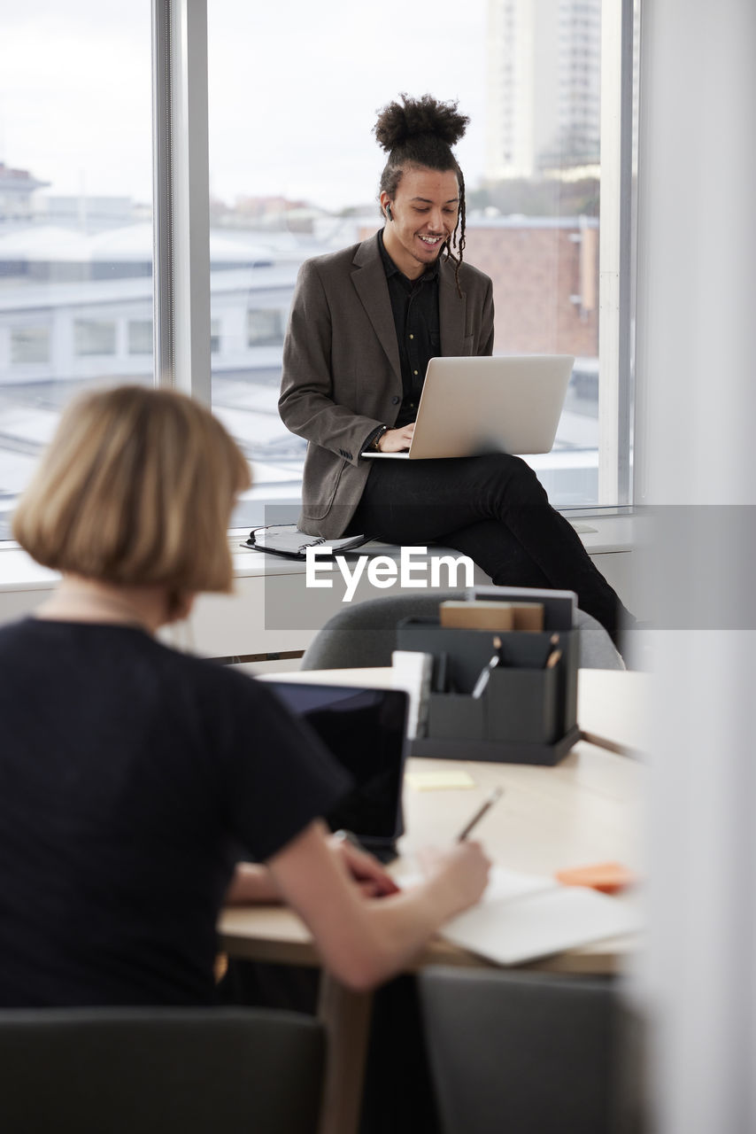 Business people working on laptops in office