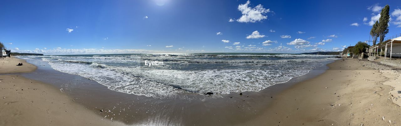 scenic view of beach against blue sky