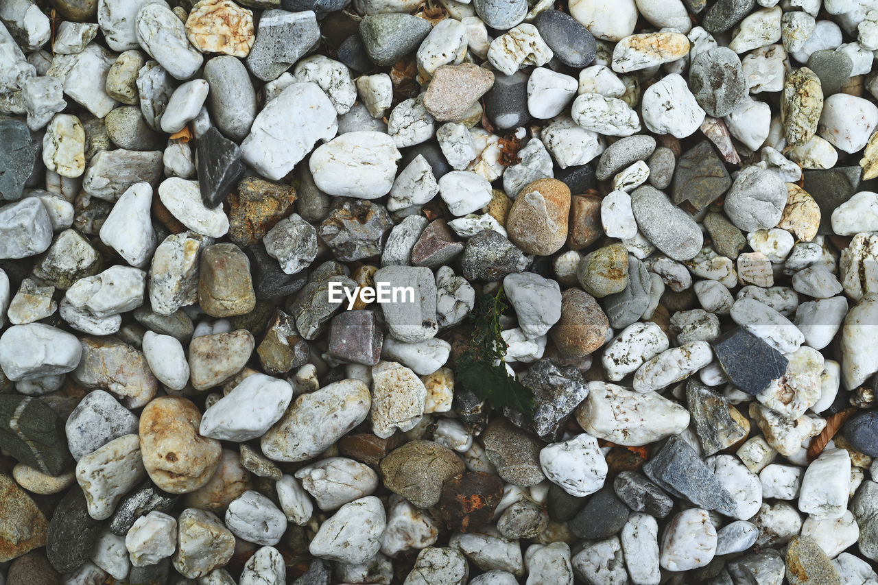 large group of objects, full frame, backgrounds, abundance, rock, gravel, stone, no people, rubble, day, stone wall, pebble, textured, high angle view, nature, soil, outdoors, directly above, land, pattern, close-up