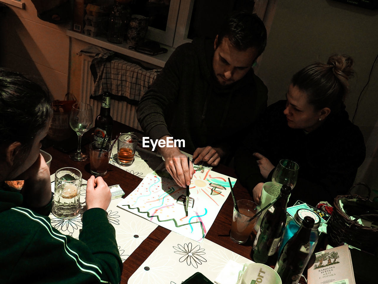 PEOPLE SITTING ON TABLE IN CAFE