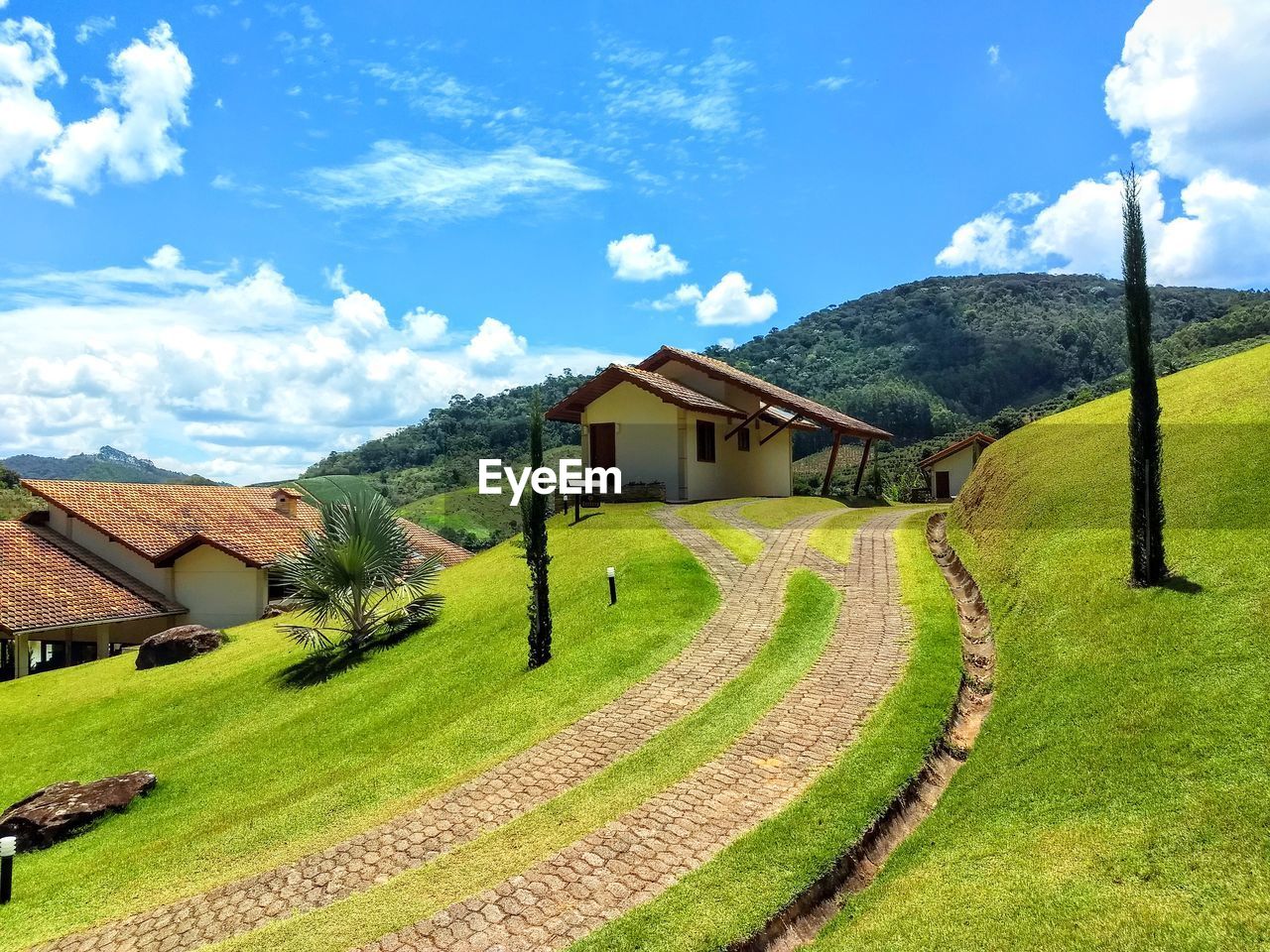 Scenic view of landscape and houses against sky