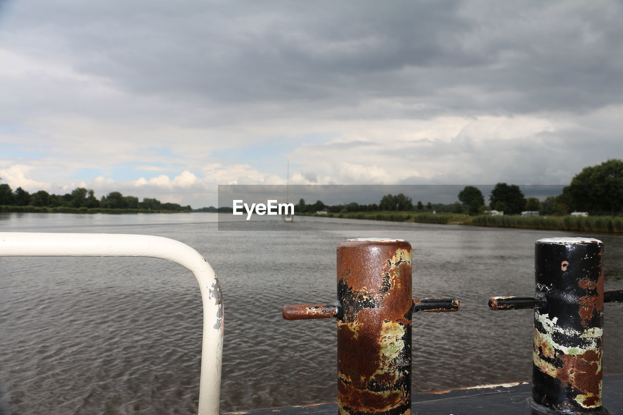 CLOSE-UP OF TREE AGAINST RIVER