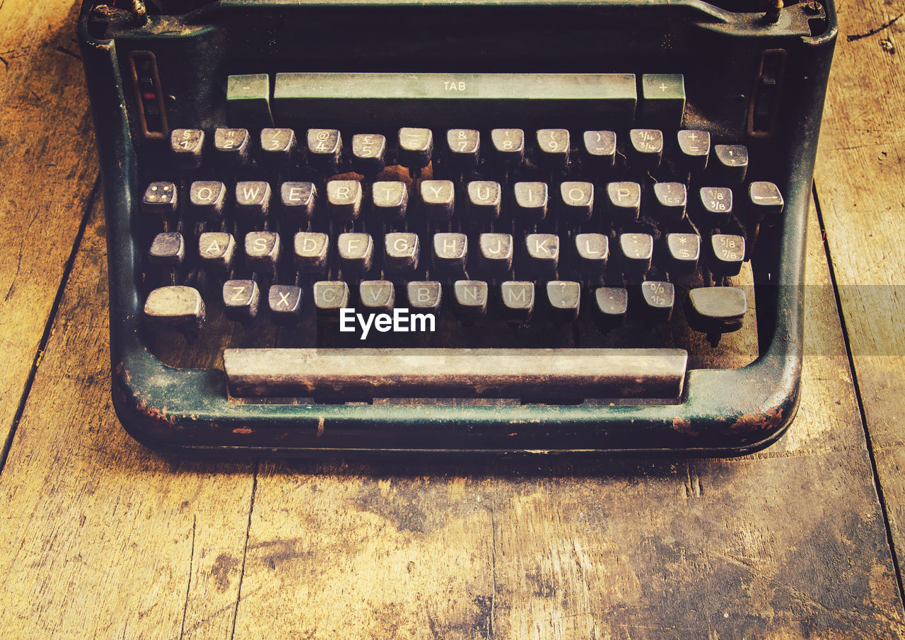High angle view of vintage typewriter on wooden table