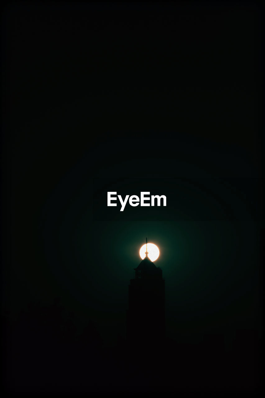 darkness, copy space, illuminated, night, lighting equipment, dark, no people, architecture, moonlight, sky, built structure, light, silhouette, low angle view, full moon, nature, lighting, moon, building exterior, outdoors, light - natural phenomenon, building