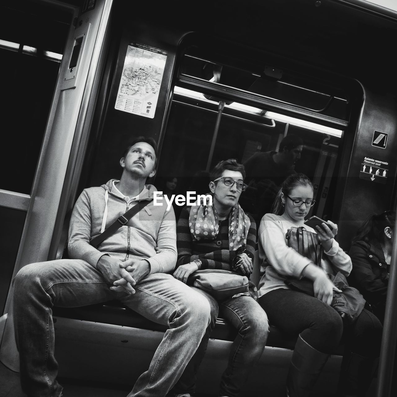 PORTRAIT OF YOUNG MAN SITTING ON TRAIN