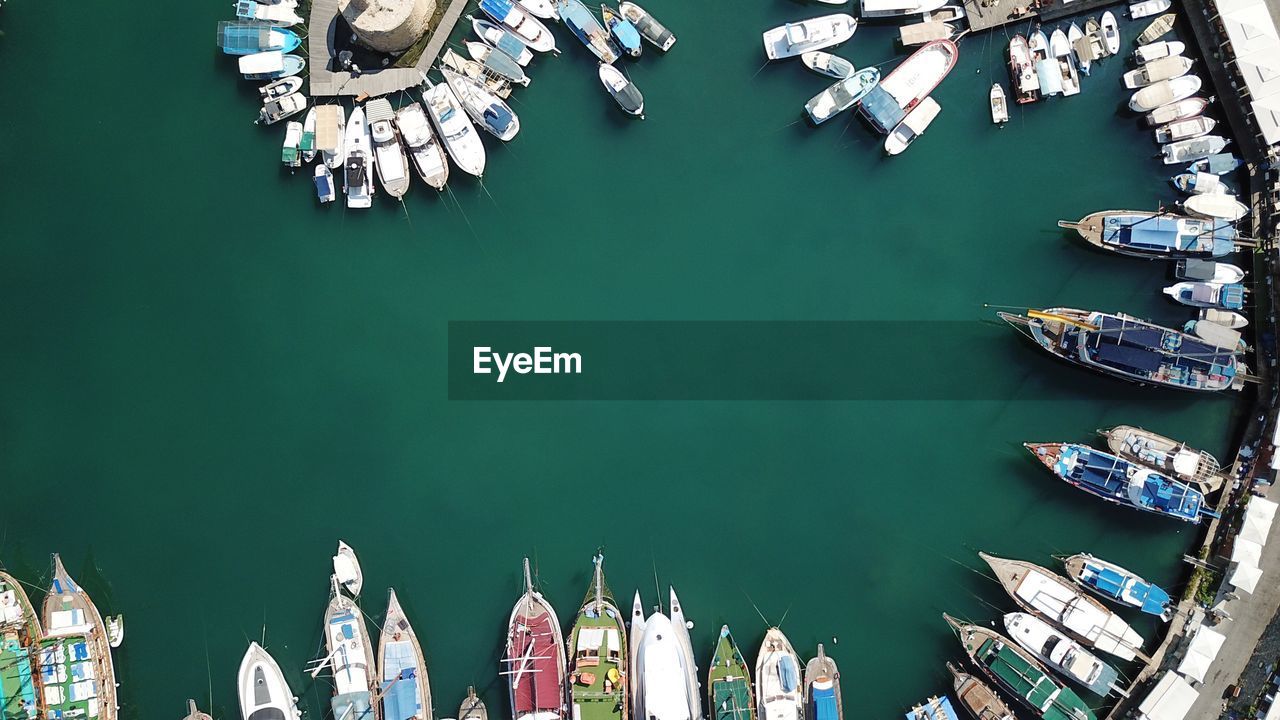 Aerial view of sailboats moored at harbor