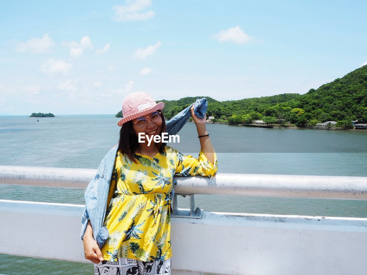 WOMAN STANDING AGAINST SEA