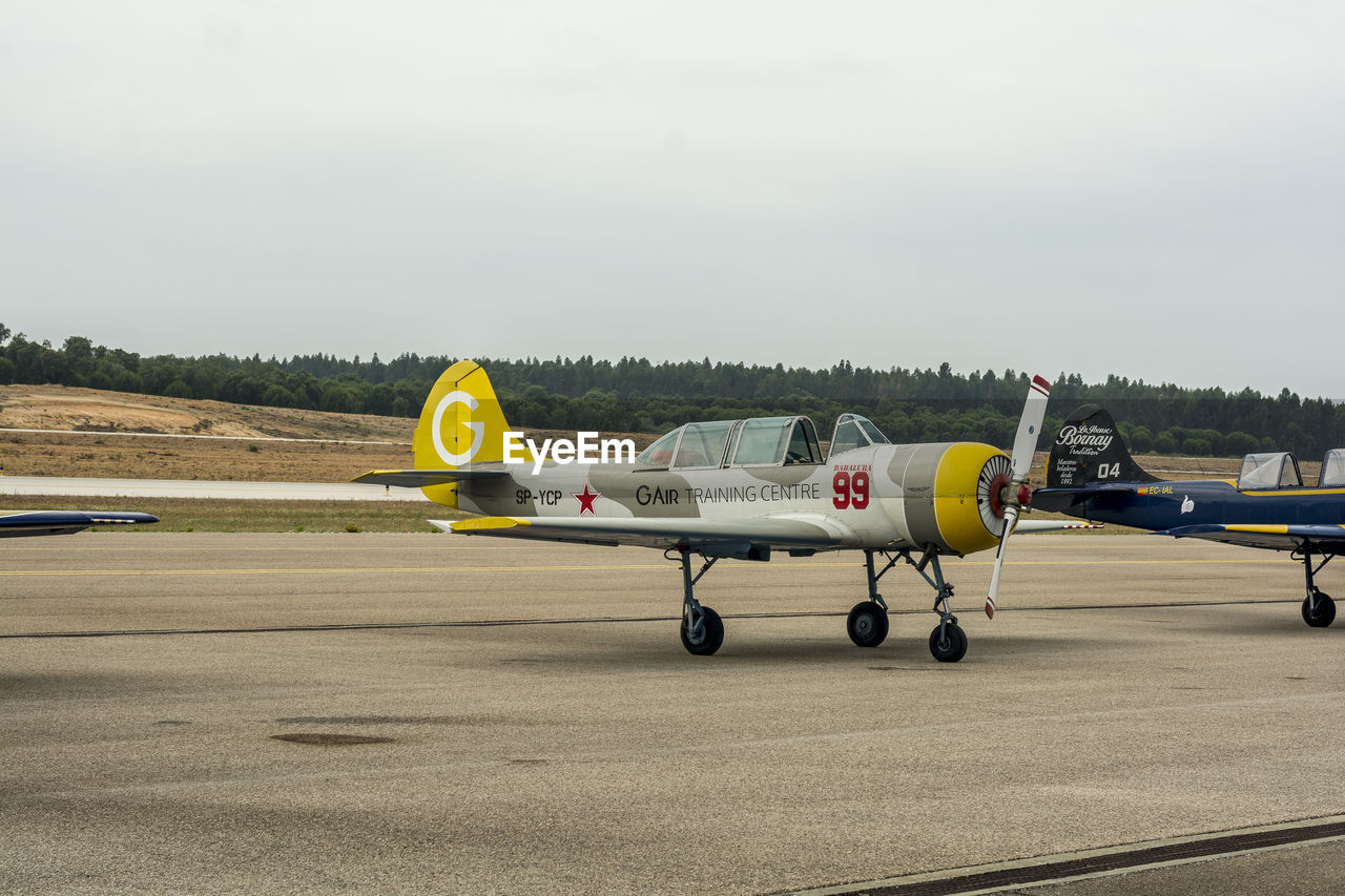 AIRPLANE ON RUNWAY AGAINST SKY