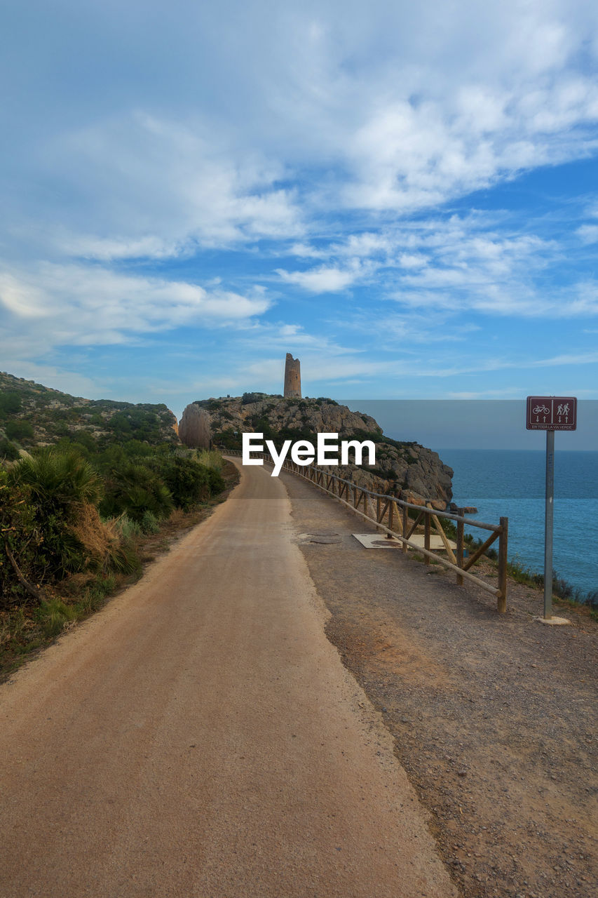 VIEW OF ROAD BY SEA AGAINST SKY