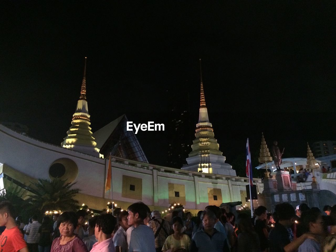 Crowd outside wat yannawa against clear sky at night