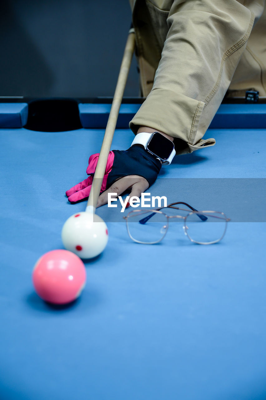 low section of woman playing pool