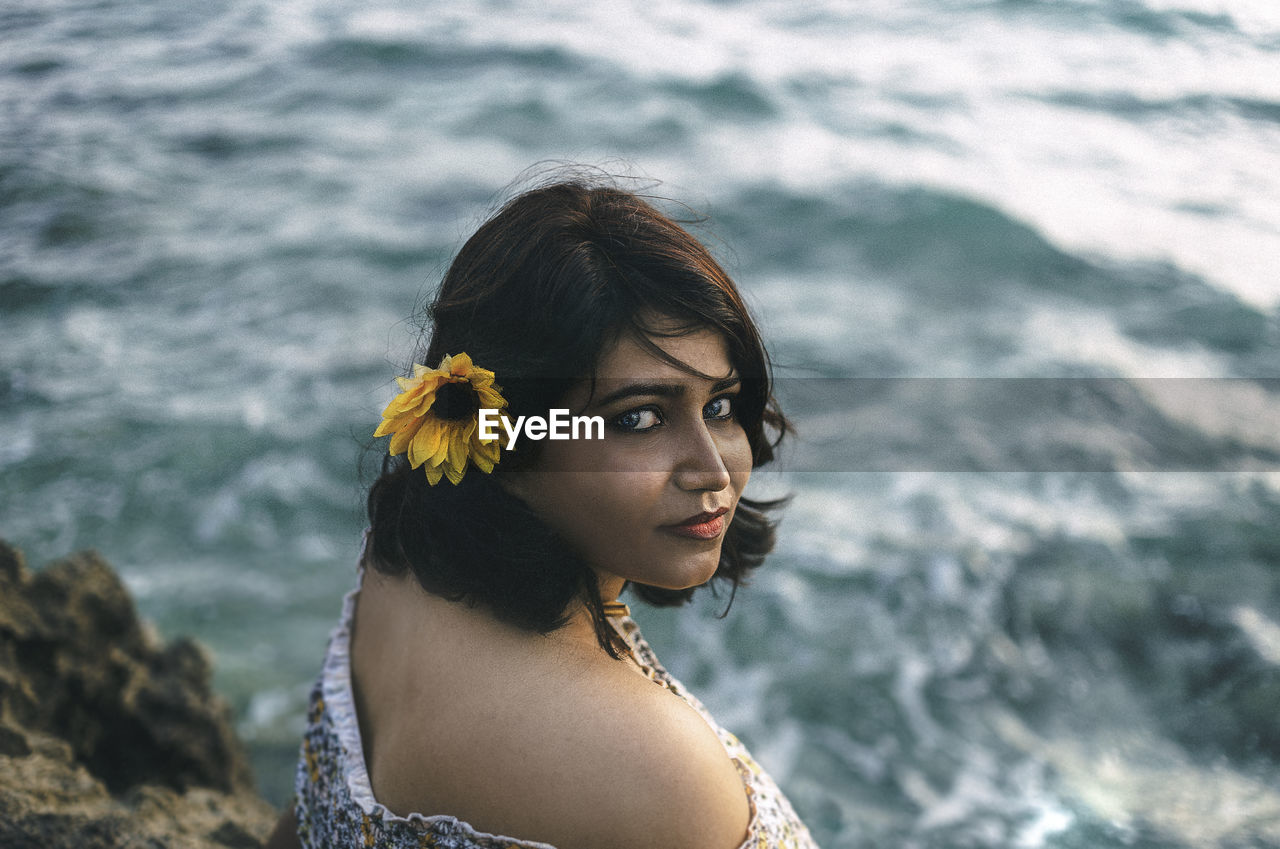 Portrait of woman against sea