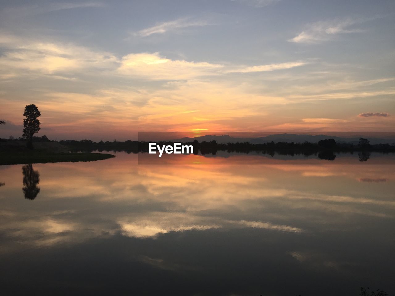 Scenic view of lake against sky during sunset