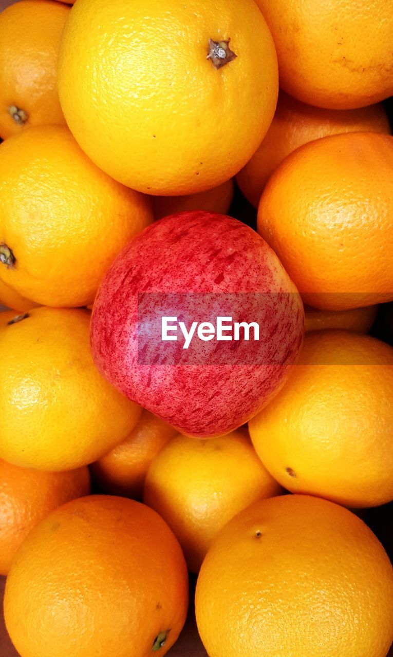 Close-up of apple and oranges for sale at market