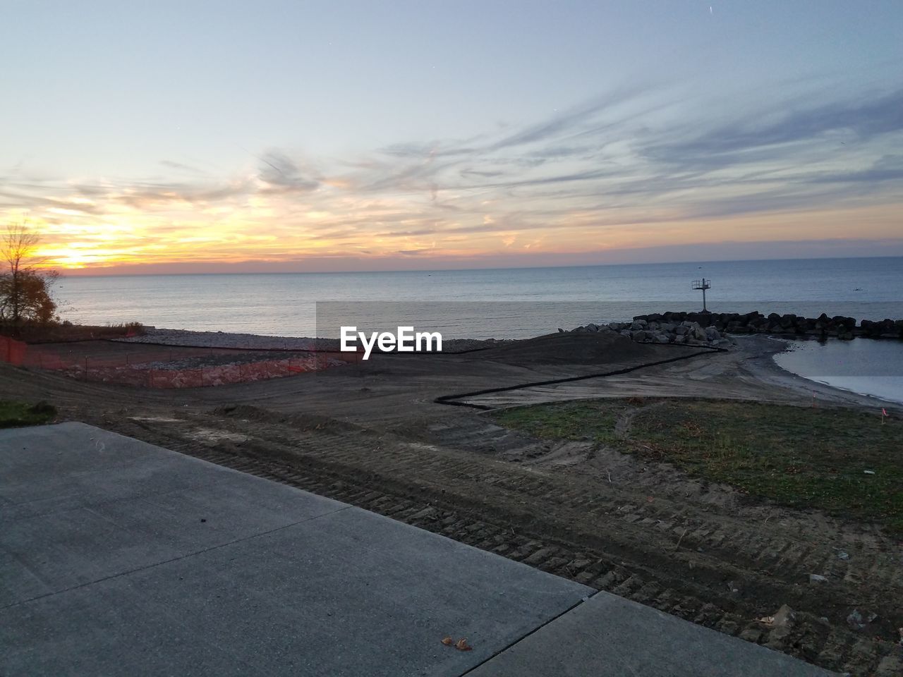 Scenic view of beach against sky during sunset