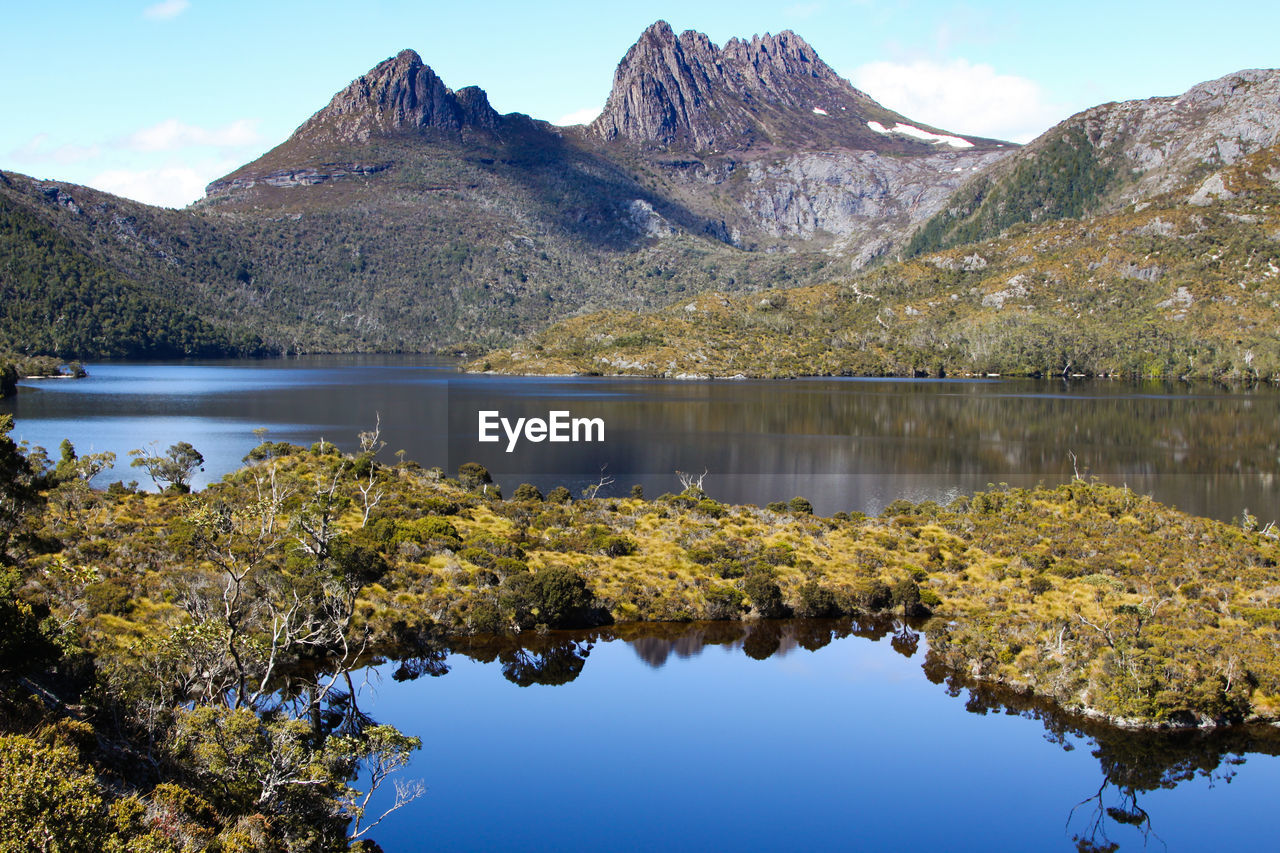 Scenic view of dove lake and mountains against sky