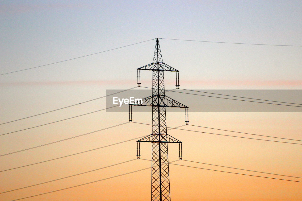 Low angle view of electricity pylon against sky