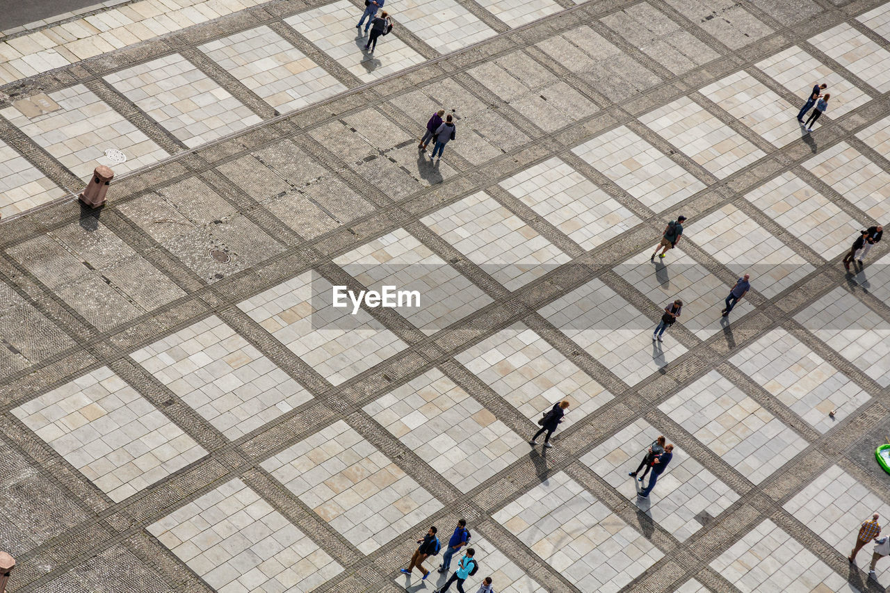 HIGH ANGLE VIEW OF PEOPLE WALKING ON FLOOR