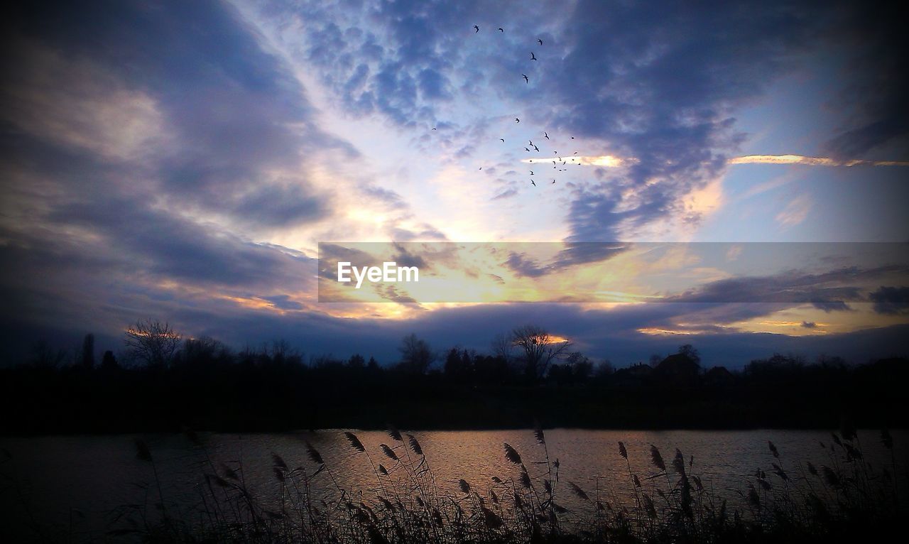 SCENIC VIEW OF SUNSET OVER LAKE