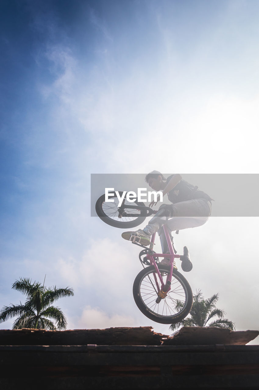 PERSON RIDING BICYCLE ON ROAD