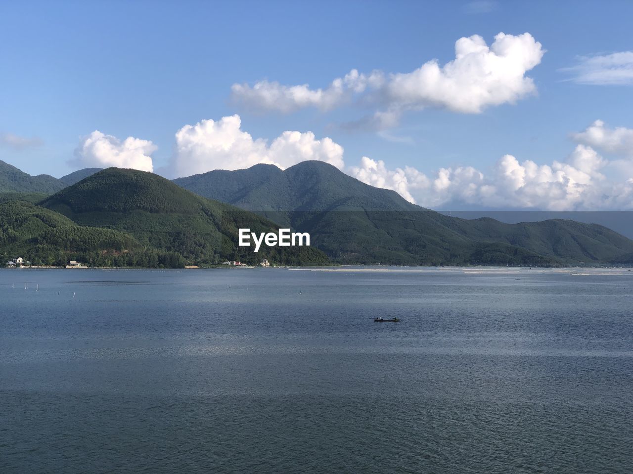 Scenic view of sea and mountains against sky