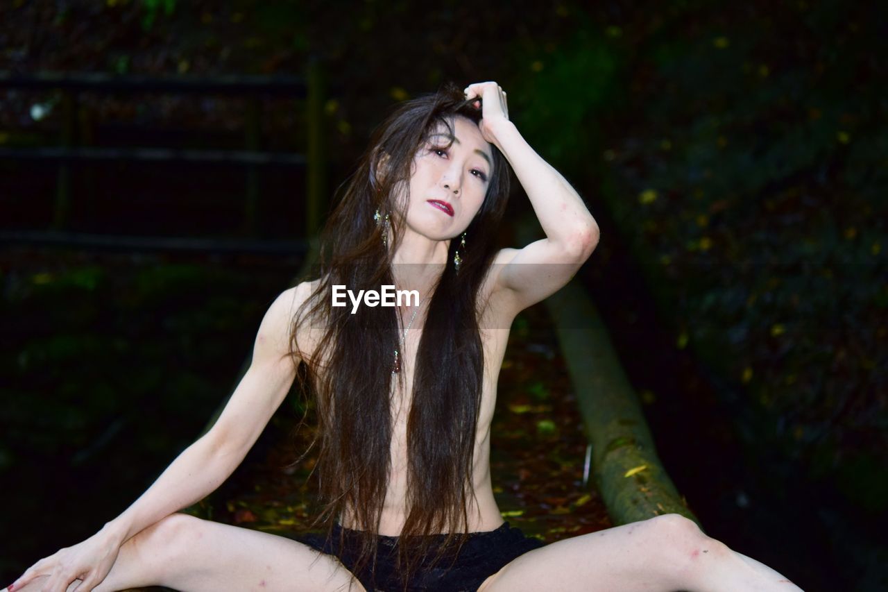 Portrait of a young woman sitting outdoors