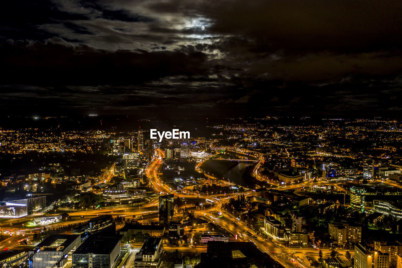 High angle view of illuminated city buildings at night