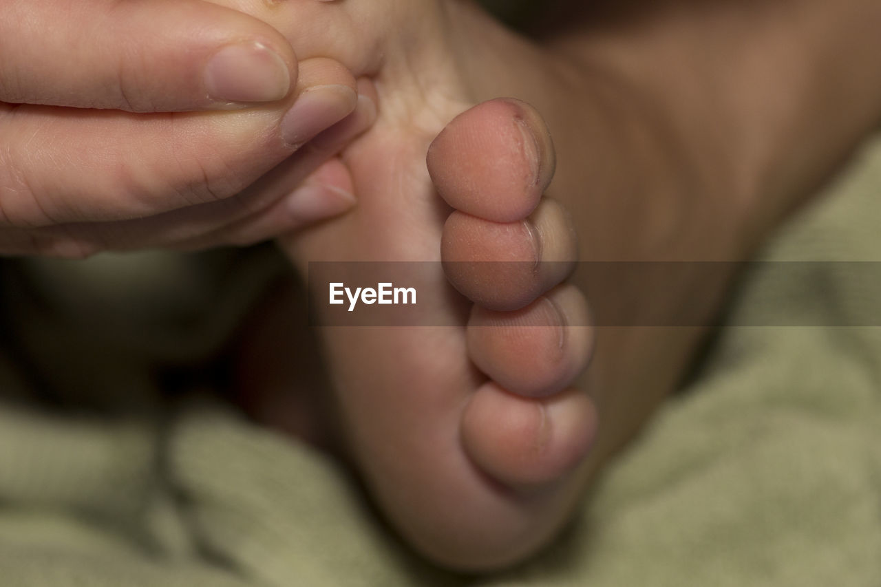 Cropped image of person touching foot