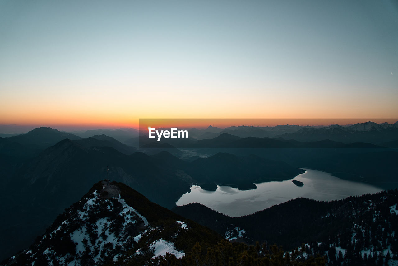 Scenic view of snowcapped mountains against sky during sunset